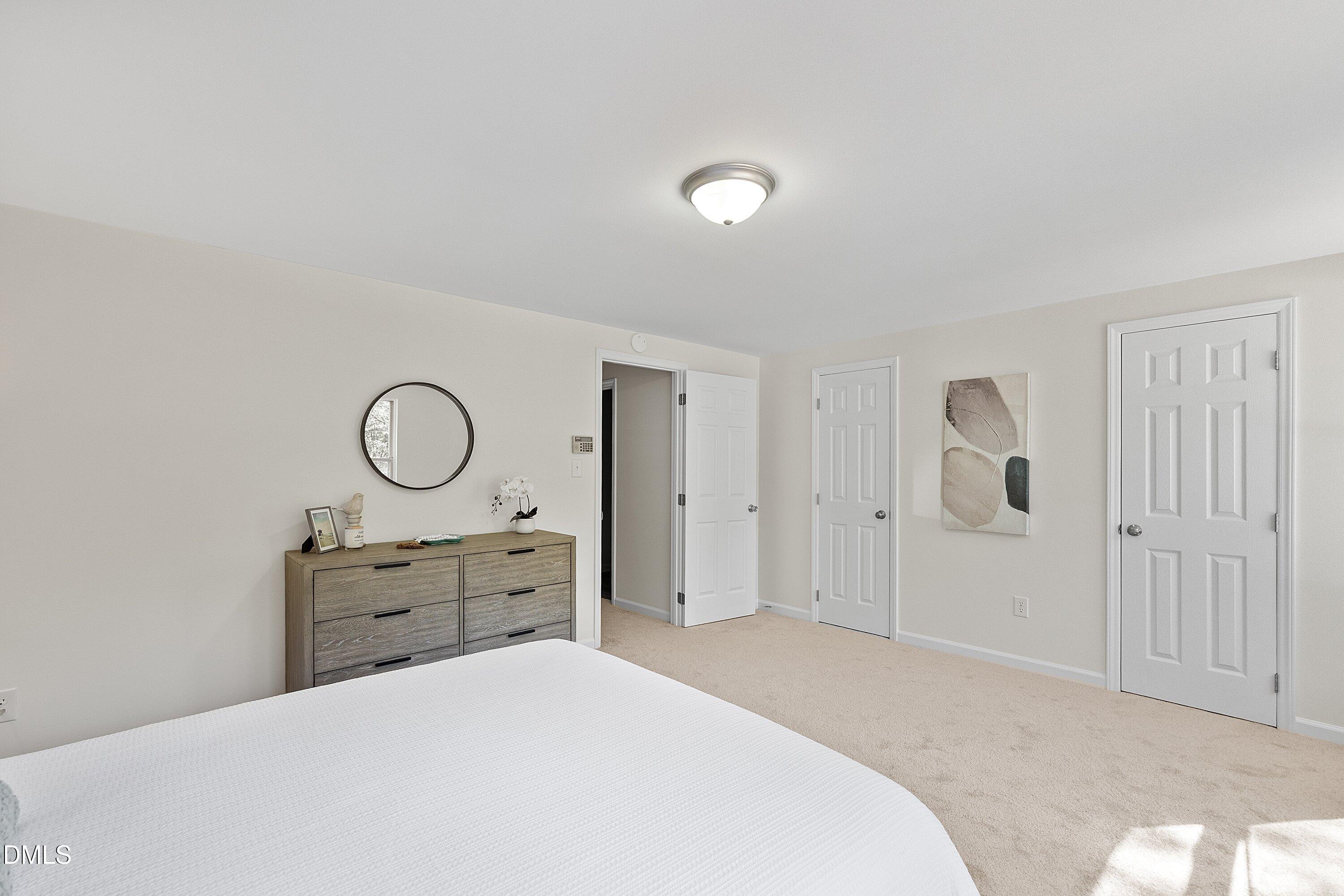 632 Middleton Avenue Cary, NC 27513 - Photo 23 of 34 a bedroom with a bed and cabinets