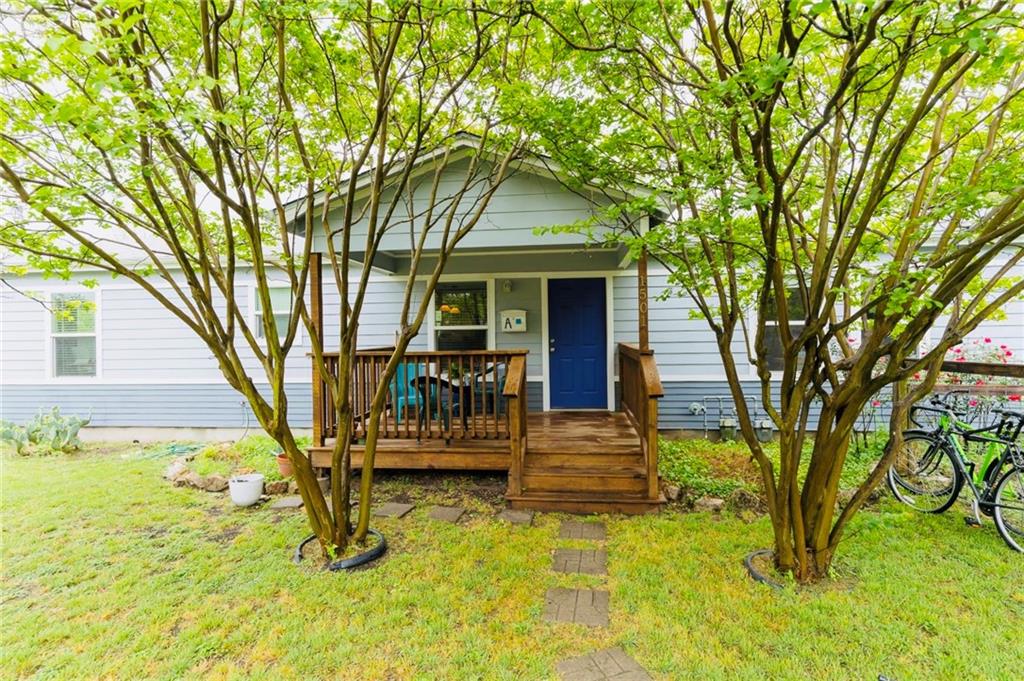 a view of house with a backyard