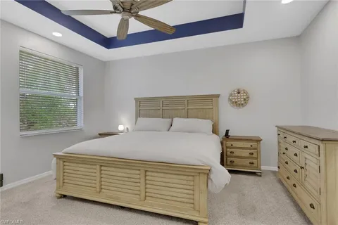 a bedroom with a bed and a ceiling fan