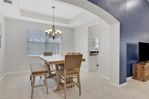 a dining room with furniture and chandelier kitchen view