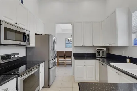 a kitchen with stainless steel appliances a stove microwave and refrigerator
