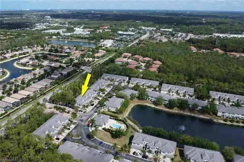 an aerial view of lake and residential houses with outdoor space
