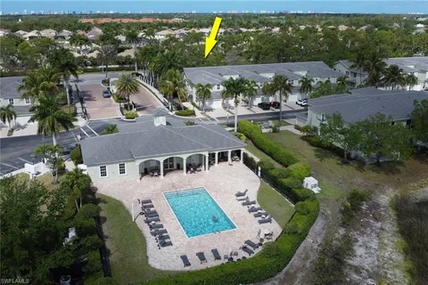 an aerial view of a house with yard swimming pool and outdoor seating