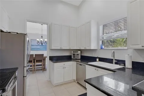 a kitchen with granite countertop a cabinets and white appliances