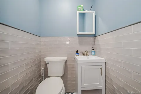 a bathroom with a toilet sink and mirror