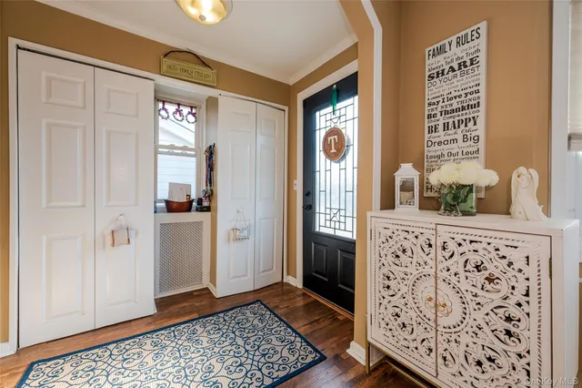 a view of a hallway with windows and wooden floor