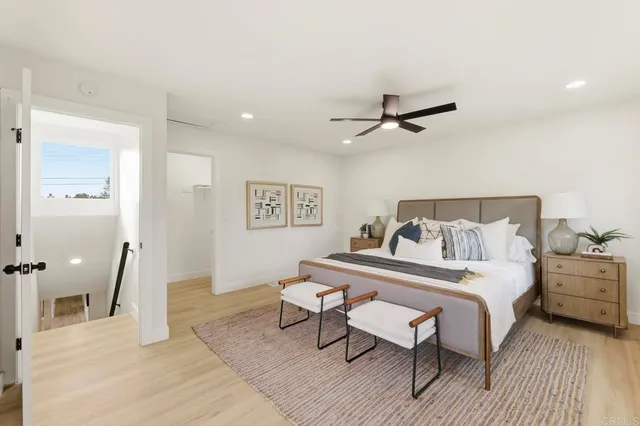 a bedroom with a bed and a ceiling fan