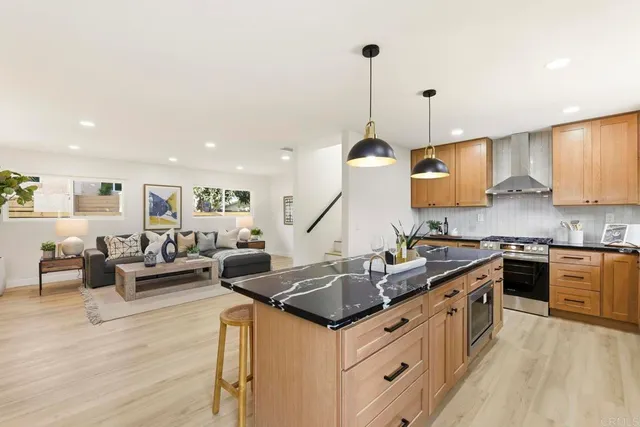 a kitchen with granite countertop a sink counter top space and stainless steel appliances