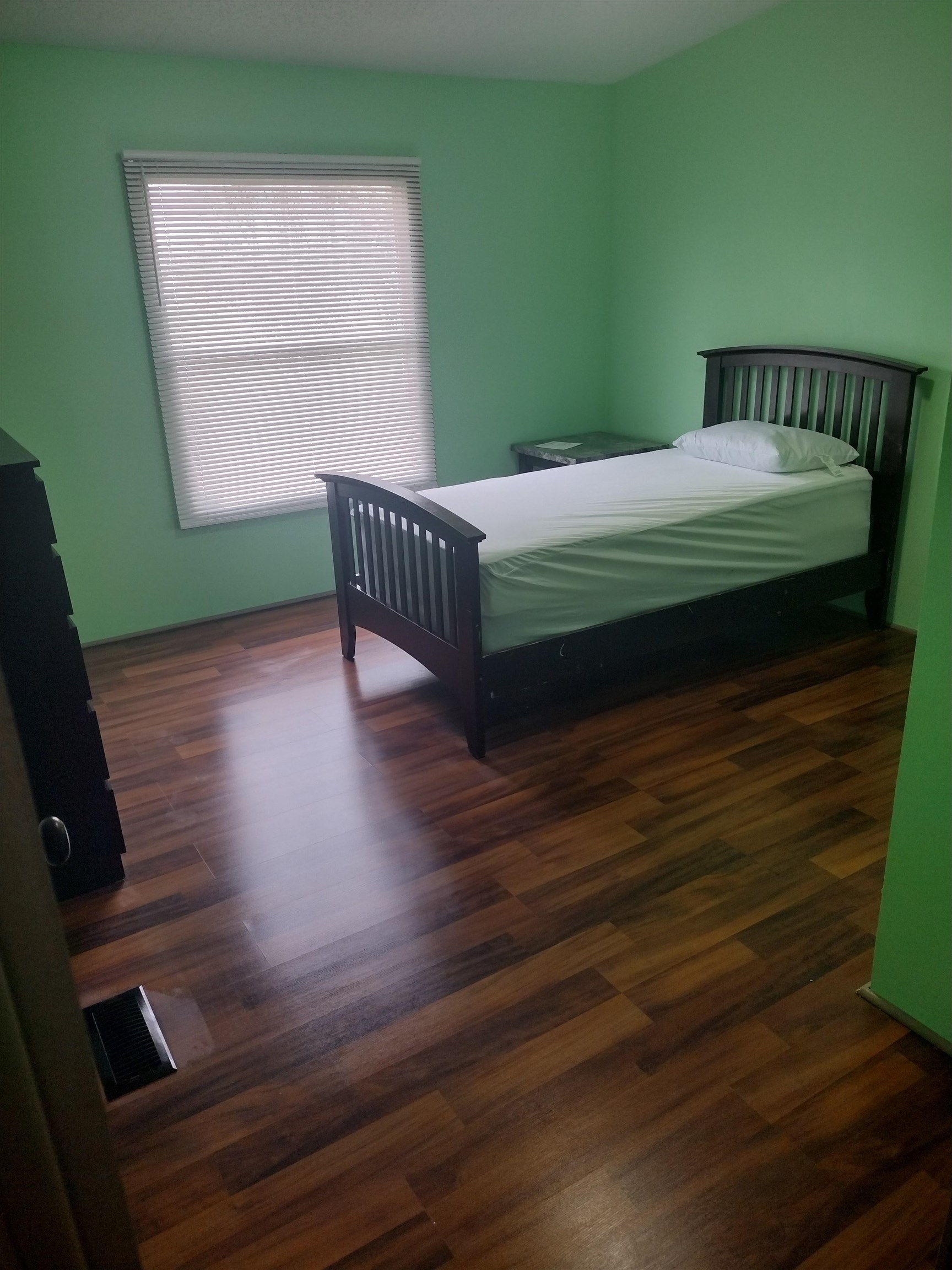 348 Sanford Road Covington, TN 38019 - Photo 8 of 23 a bed sitting in a bedroom next to a window