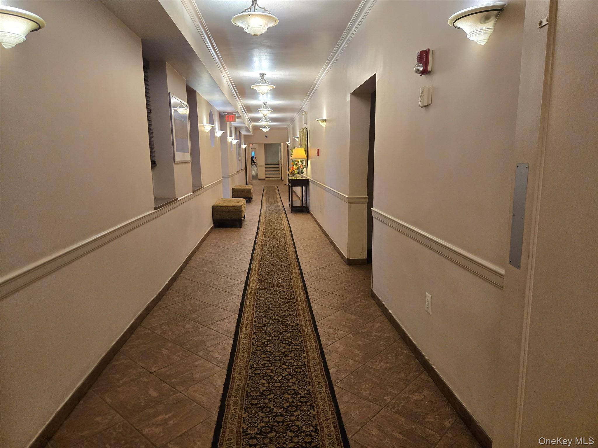 765 Bronx River Road, Unit 3F Bronxville, NY 10708 - Photo 25 of 28 Long hallway featuring extensive tile flooring with an ornate runner