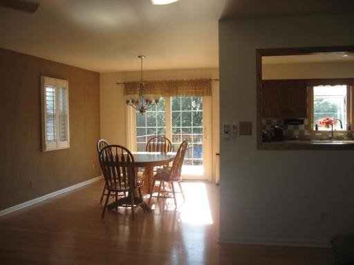 1029 South Cooper Road New Lenox, IL 60451 - Photo 3 of 11 a view of a dining room with furniture window and wooden floor