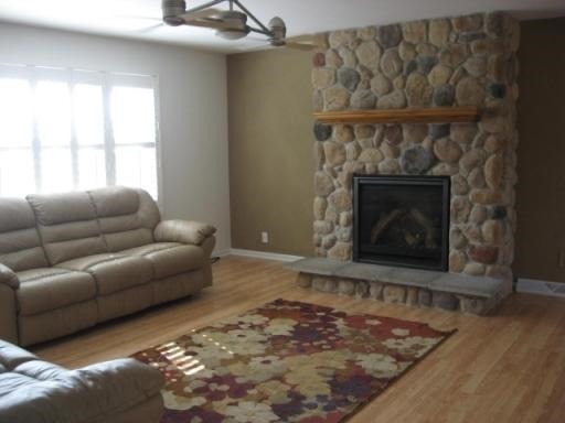 1029 South Cooper Road New Lenox, IL 60451 - Photo 4 of 11 a living room with furniture a window and a fireplace
