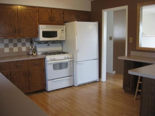 1029 South Cooper Road New Lenox, IL 60451 - Photo 7 of 11 a kitchen with a refrigerator stove and microwave