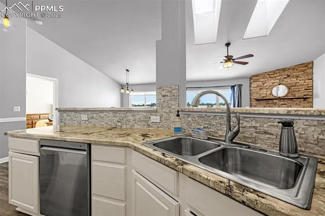 a kitchen with stainless steel appliances granite countertop a sink and cabinets