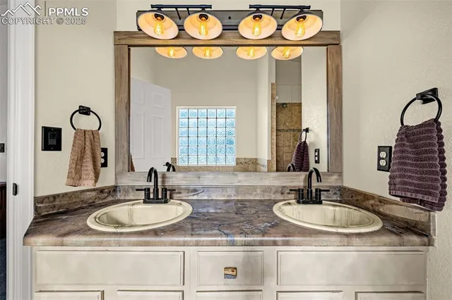 a bathroom with sinks and a mirror