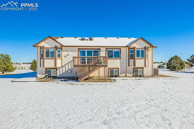 a view of a house with wooden fence