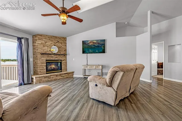 a living room with furniture a flat screen tv and a fireplace