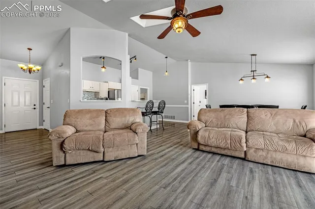 a living room with furniture and a wooden floor