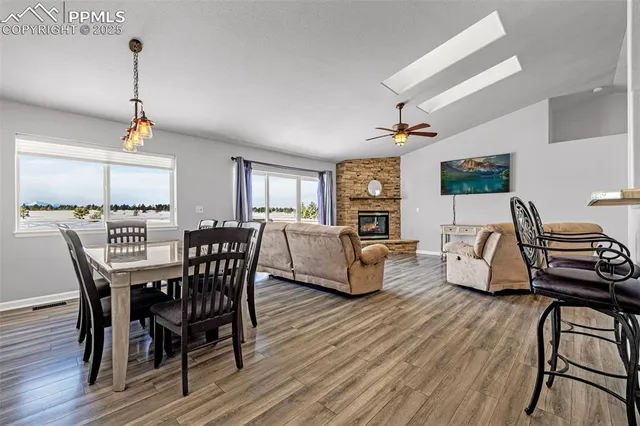a dining room with furniture and wooden floor
