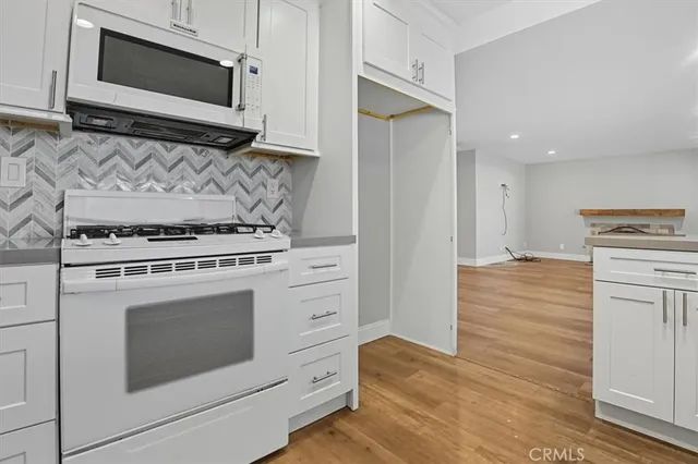 a kitchen with a stove and a microwave