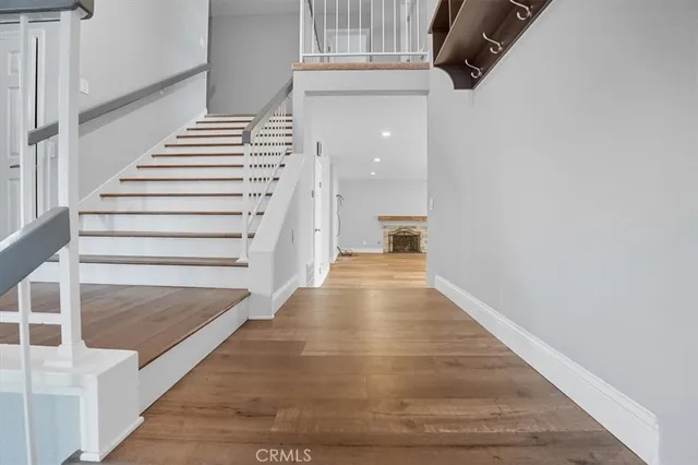 a view of entryway and hall with wooden floor