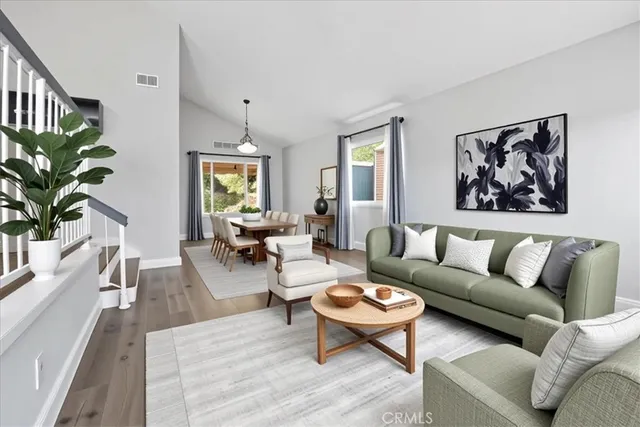a living room with furniture and a potted plant