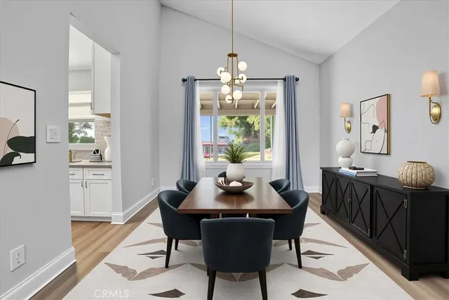 a dining room with furniture a chandelier and wooden floor
