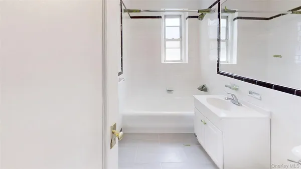 a bathroom with a sink a mirror and a bathtub