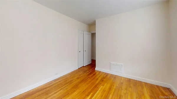a view of a room with wooden floor