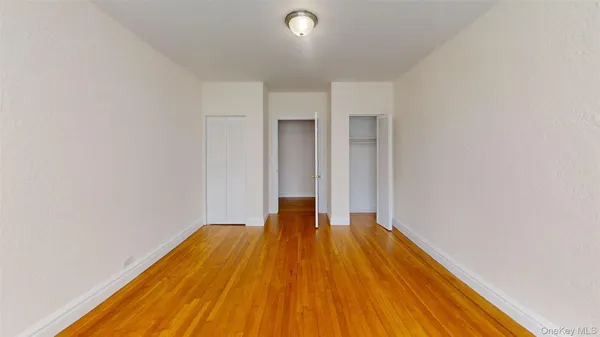 a view of a room with wooden floor and a window