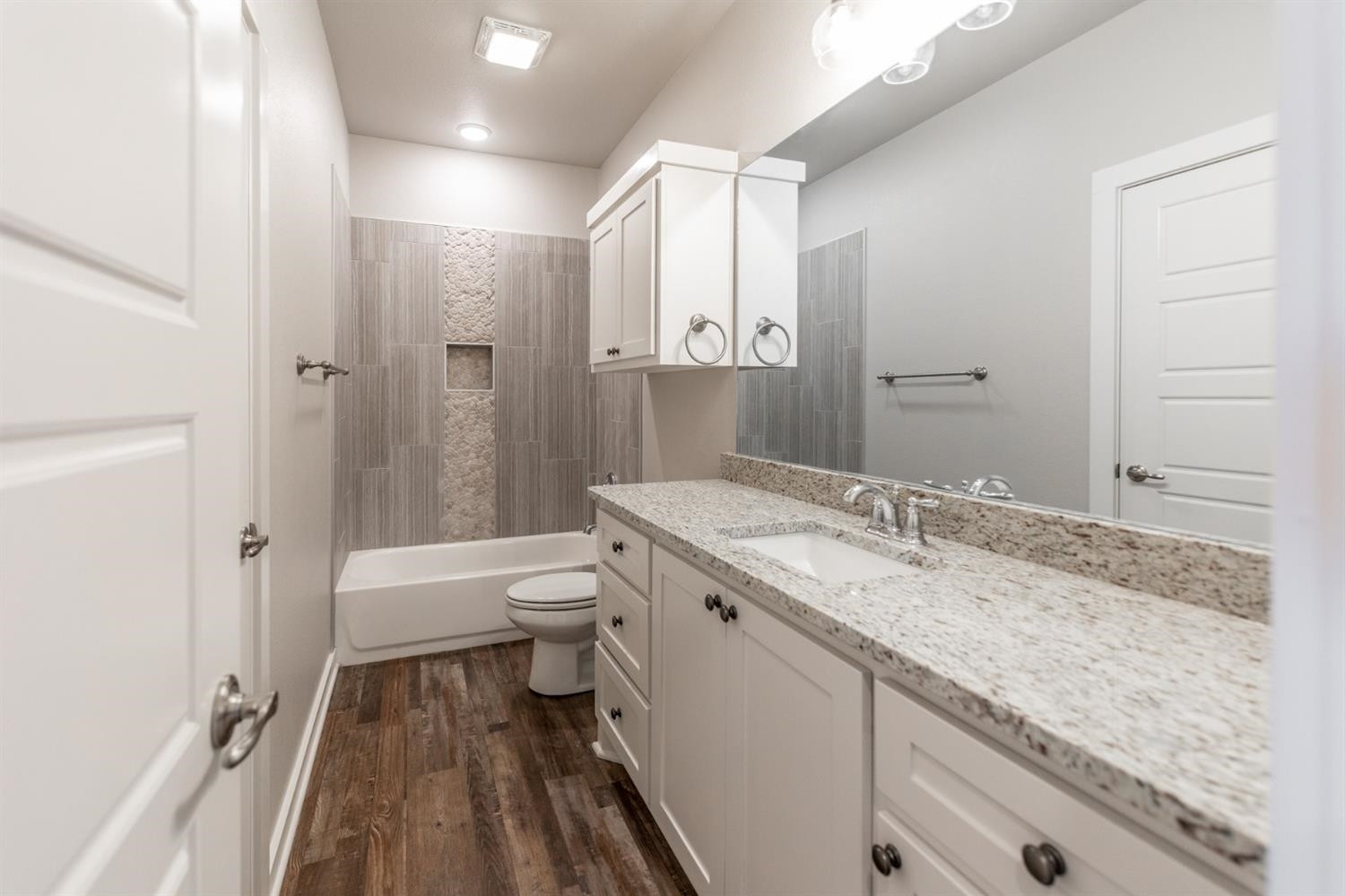 13311 Gardner Lubbock, TX 79424 - Photo 15 of 32 a bathroom with a granite countertop sink a toilet and shower