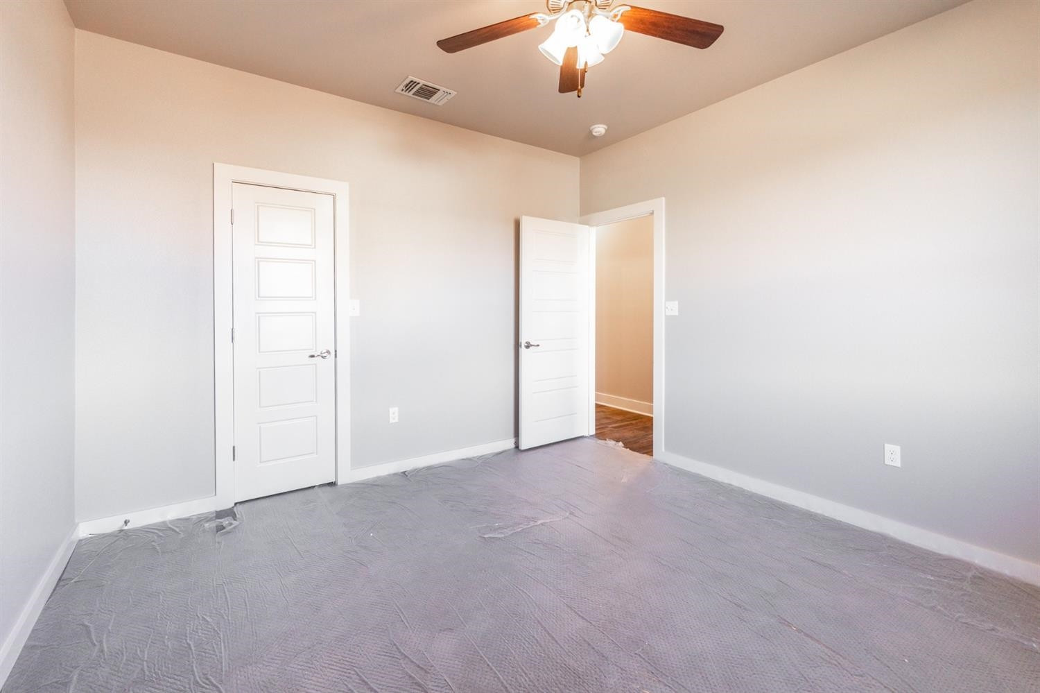 13311 Gardner Lubbock, TX 79424 - Photo 17 of 32 an empty room with a chandelier fan and a ceiling fan