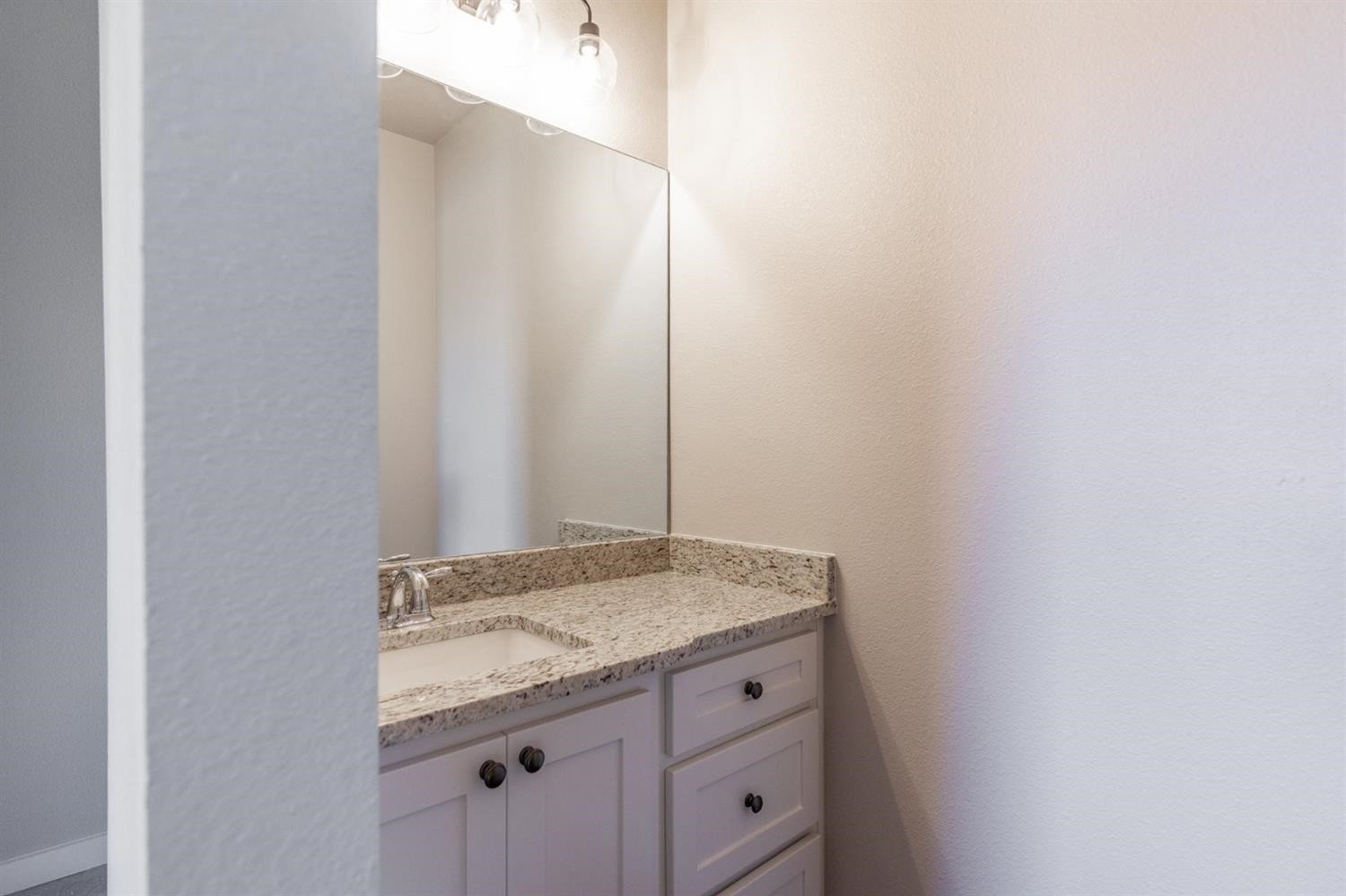 13311 Gardner Lubbock, TX 79424 - Photo 24 of 32 a bathroom with a granite countertop sink and vanity