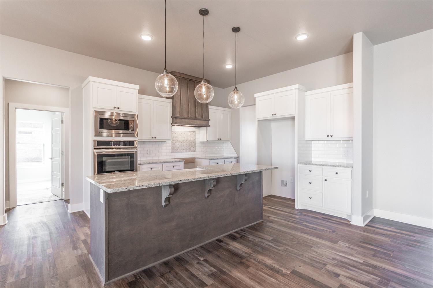 13311 Gardner Lubbock, TX 79424 - Photo 5 of 32 a large kitchen with cabinets wooden floor and stainless steel appliances
