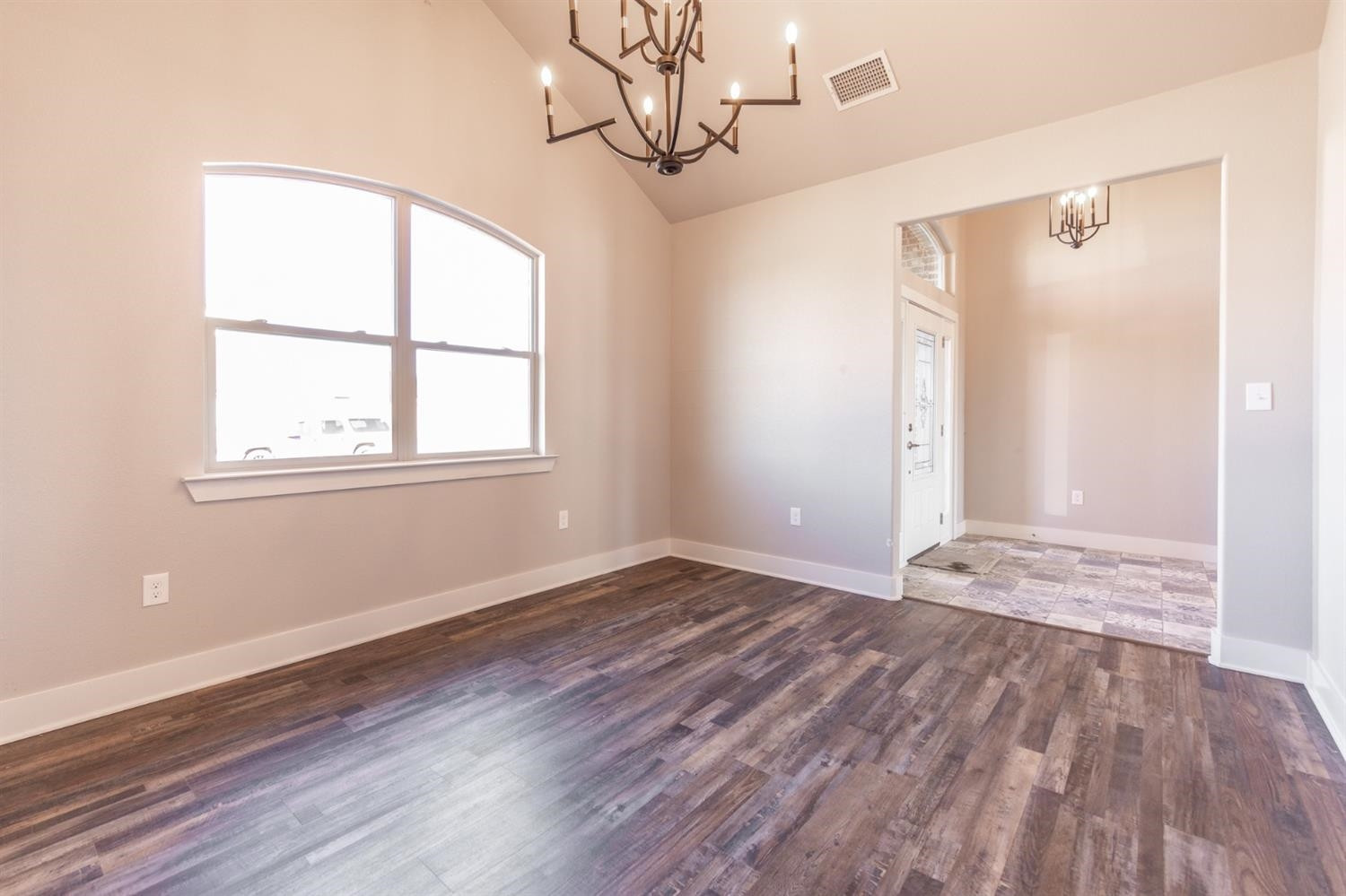 13311 Gardner Lubbock, TX 79424 - Photo 9 of 32 a view of an empty room with wooden floor and a window