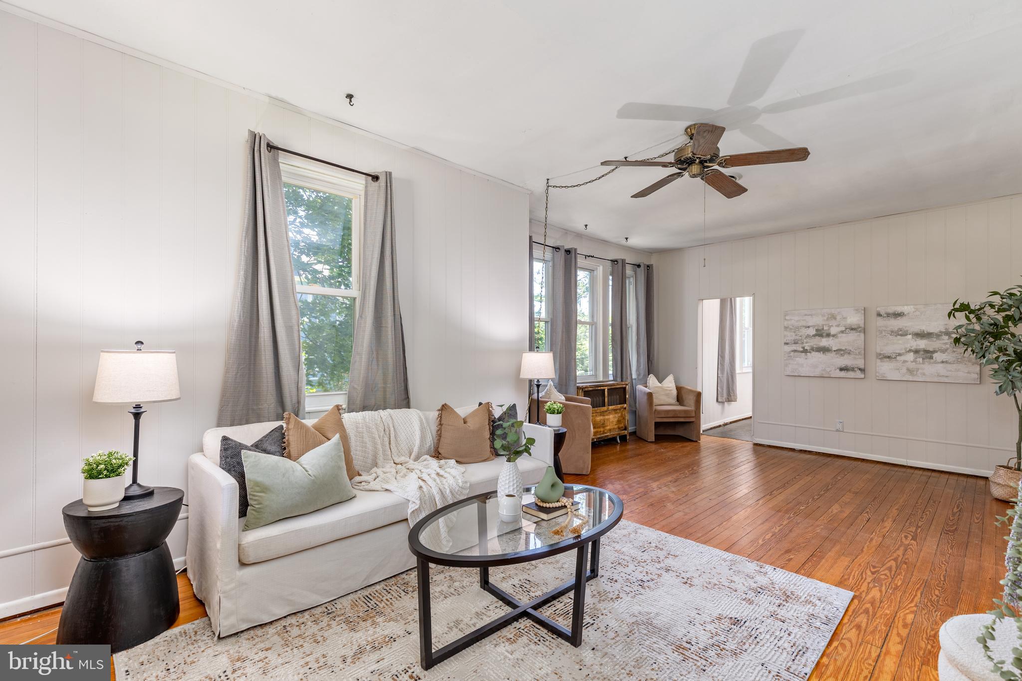 6426 Sherwood Road Baltimore, MD 21239 - Photo 5 of 43 a living room with furniture and a wooden floor