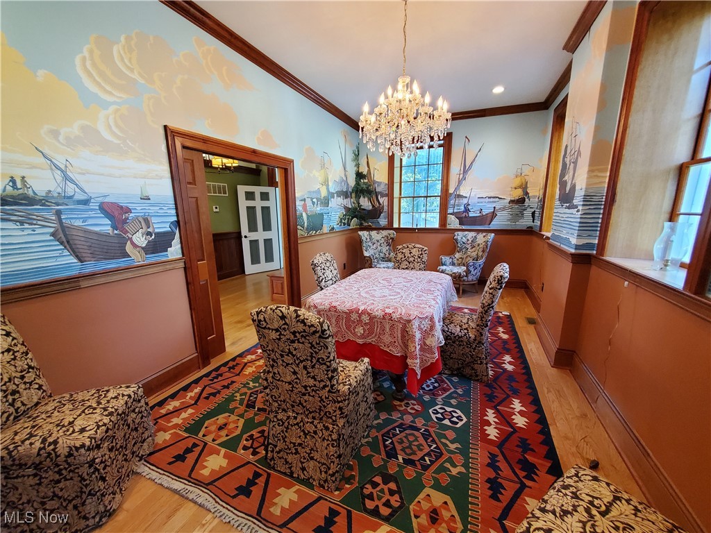 150 Main Street Hayesville, OH 44805 - Photo 14 of 50 Dining room with a chandelier, light wood-style flooring, and crown molding.