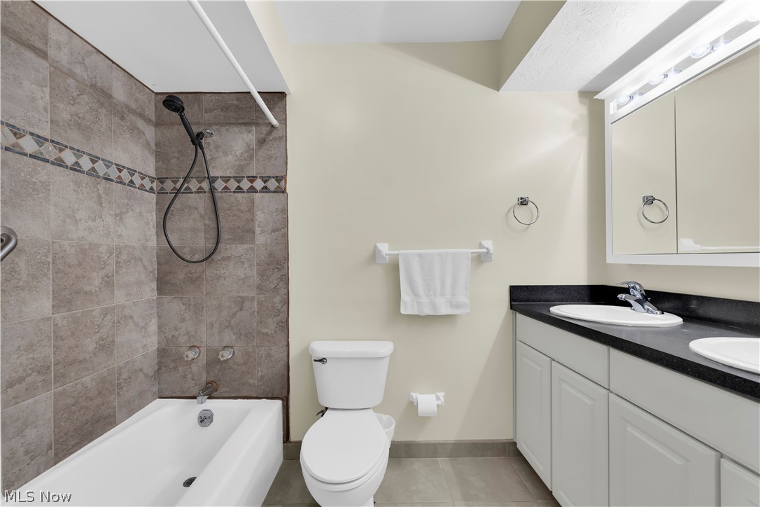 985 Canyon View Road, Unit 108D Northfield, OH 44067 - Photo 14 of 18 Full bath with shower / bath combination, double vanity, and light tile patterned floors