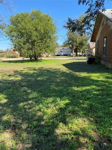 a view of yard with swimming pool and green space
