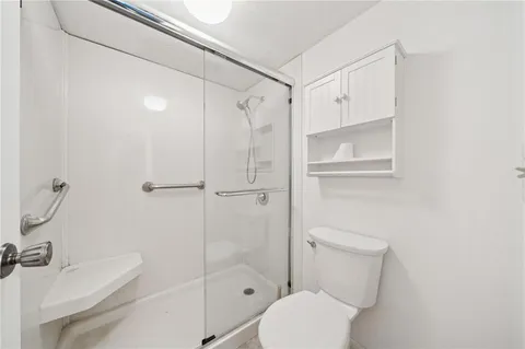 a white toilet sitting next to a bathroom sink