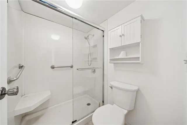 a white toilet sitting next to a bathroom sink