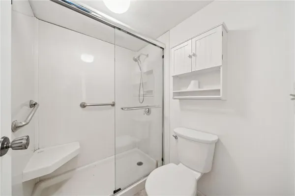 a white toilet sitting next to a bathroom sink