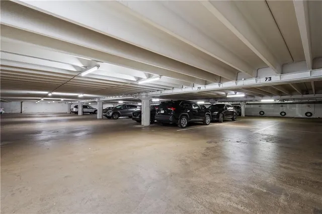 a swimming pool with yard and trees in the background