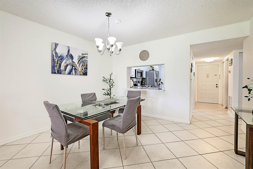 3485 Environ Boulevard, Unit C106 Lauderhill, FL 33319 - Photo 14 of 33 a view of a dining room with furniture and chandelier