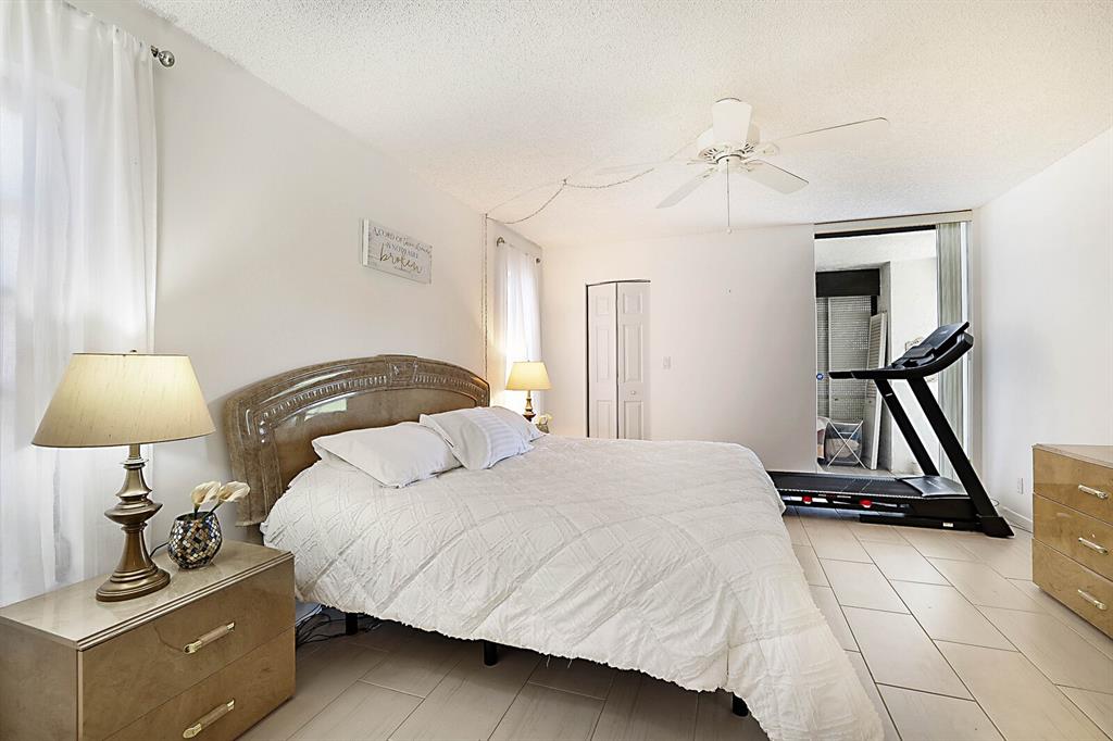3485 Environ Boulevard, Unit C106 Lauderhill, FL 33319 - Photo 21 of 33 a bedroom with a bed and a chandelier