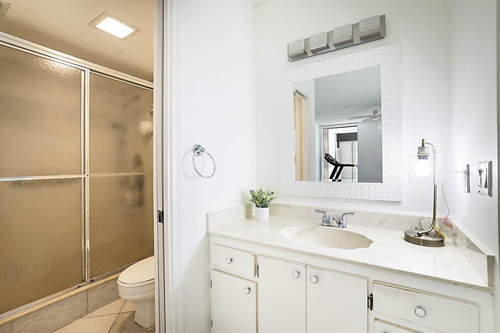 3485 Environ Boulevard, Unit C106 Lauderhill, FL 33319 - Photo 22 of 33 a bathroom with a shower sink vanity mirror and toilet
