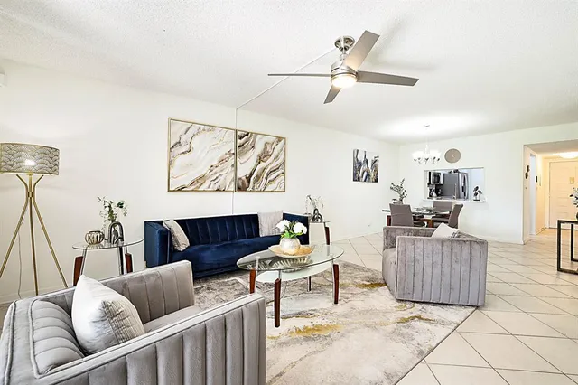 a kitchen with granite countertop a refrigerator stove and microwave