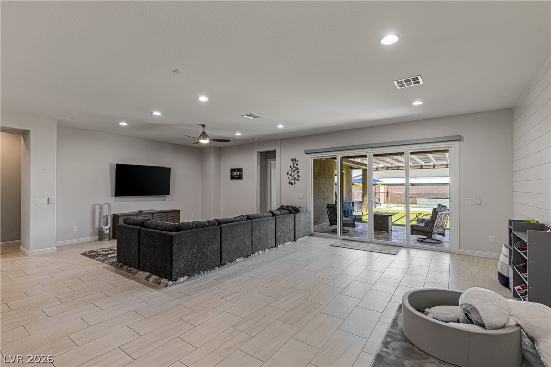7036 Arabian Ridge Street Las Vegas, NV 89131 - Photo 16 of 64 Large great room area perfect for entertaining with large sliding glass door equipped with automated shades.