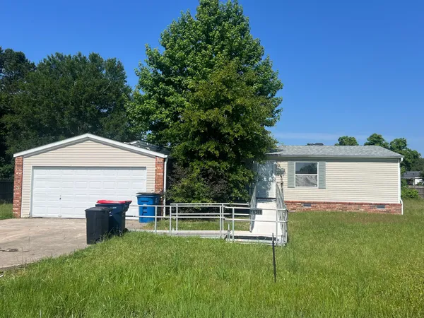 a front view of house with yard and green space