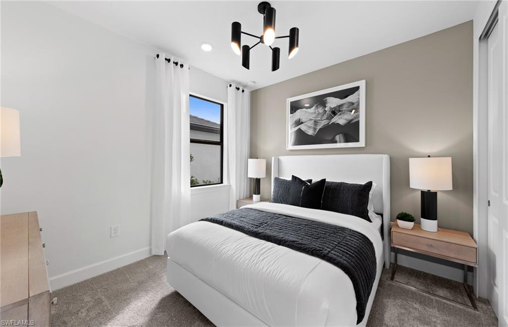 1879 Mesa Lane Naples, FL 34120 - Photo 11 of 24 a bedroom with a large bed and a chandelier